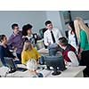 group of students with teacher in computer lab classrom learrning lessons,  get help and support
