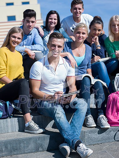 Group portrait of happy students outside sitting on steps have fun Group portrait of happy students outside sitting on steps have fun