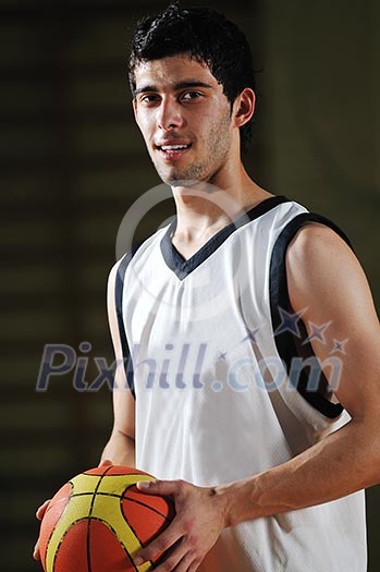 one basket ball game player standing in sport gym with ball one basket ball game player standing in sport gym with ball