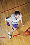 one healthy young  man play basketball game in school gym indoor