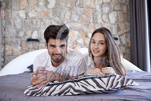 happy young couple relax and have fun in bed happy young couple relax and have fun in bed