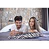 happy young couple relax and have fun in bed