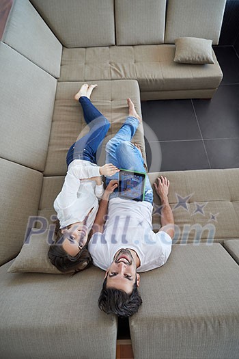 romantic relaxed young couple at modern home using tablet computer romantic relaxed young couple at modern home using tablet computer
