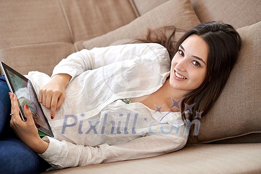 woman at home using tablet computer woman at home using tablet computer