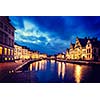 Vintage retro hipster style image of travel Europe Belgium background - Ghent canal, Graslei and Korenlei streets in twlight the evening. Ghent, Belgium