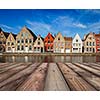 Wooden planks table with typical European Europe cityscape view -  canal and medieval houses in background. Brugge, Belgium