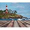 Wood planks floor with old lighthouse and sea waves in background