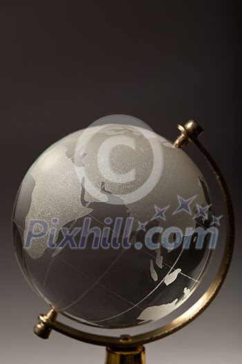 Crystal glass globe on gradient gray background Crystal glass globe on gradient gray background