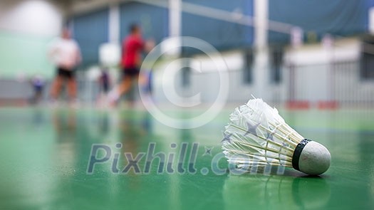 Badminton - badminton courts with players competing Badminton - badminton courts with players competing