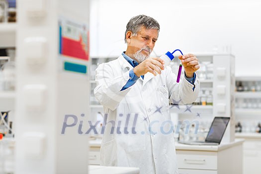 Senior male researcher carrying out scientific research in a lab (shallow DOF; color toned image) Senior male researcher carrying out scientific research in a lab (shallow DOF; color toned image)