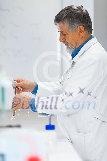 Senior male researcher carrying out scientific research in a lab (shallow DOF; color toned image) Senior male researcher carrying out scientific research in a lab (shallow DOF; color toned image)
