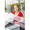 In the library - pretty, female student with using a copy machine (color toned image)