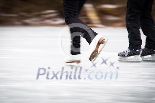 Young woman ice skating outdoors on a pond on a freezing winter day Young woman ice skating outdoors on a pond on a freezing winter day