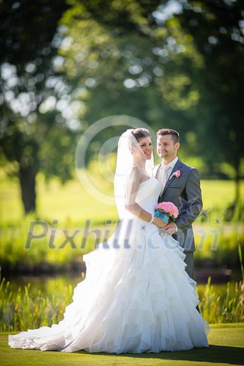 Portrait of a young wedding couple on their wedding day Portrait of a young wedding couple on their wedding day