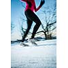 Young woman running outdoors on a cold winter day (motion blurred image)