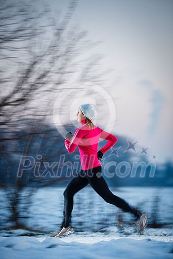 Young woman running outdoors on a cold winter day (motion blurred image) Young woman running outdoors on a cold winter day (motion blurred image)