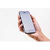 Female hand holding a smart phone, isolated on white