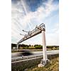 truck passing through a toll gate on a highway (motion blurred image; color toned image)