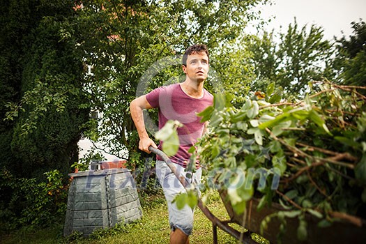 Handsome young man gardening in his garden Handsome young man gardening in his garden
