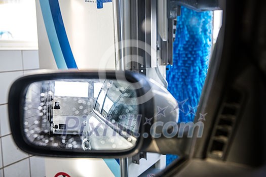 Car in a carwash - view from the interior of the vehicle Car in a carwash - view from the interior of the vehicle