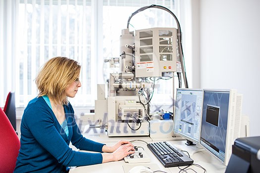 Pretty, female researcher using a microscope in a lab, doing research (color toned image) Pretty, female researcher using a microscope in a lab, doing research (color toned image)