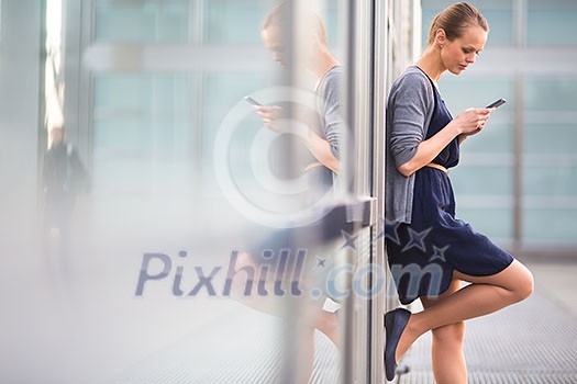 Portrait of a sleek young woman calling on a smartphone and using her laptop in a an
urban/city context (shallow DOF; color toned image) Portrait of a sleek young woman calling on a smartphone and using her laptop in a an
urban/city context (shallow DOF; color toned image)