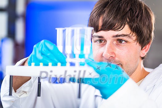 Young male researcher carrying out scientific research in a lab (shallow DOF; color toned image) Young male researcher carrying out scientific research in a lab (shallow DOF; color toned image)