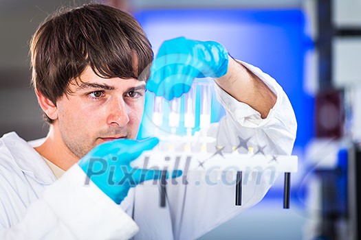 Young male researcher carrying out scientific research in a lab (shallow DOF; color toned image) Young male researcher carrying out scientific research in a lab (shallow DOF; color toned image)