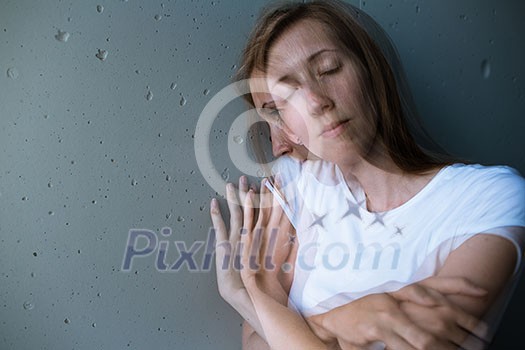 Young woman suffering from a severe depression/anxiety (color toned image; double exposure technique is used to convey the mood of unease, progression of the anxiety/depression)