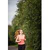 Young woman running outdoors on a lovely sunny winter/fall day