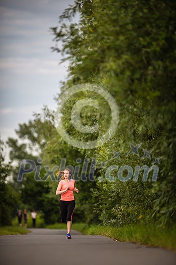 Young woman running outdoors on a lovely sunny winter/fall day Young woman running outdoors on a lovely sunny winter/fall day