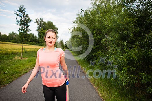 Young woman running outdoors on a lovely sunny winter/fall day - doing the necessary stretching before her run Young woman running outdoors on a lovely sunny winter/fall day - doing the necessary stretching before her run