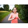 Young woman running outdoors on a lovely sunny winter/fall day
