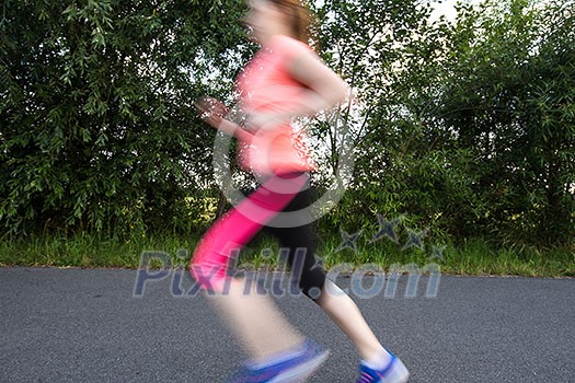 Young woman running outdoors on a lovely sunny winter/fall day (motion blurred image) Young woman running outdoors on a lovely sunny winter/fall day (motion blurred image)