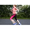 Young woman running outdoors on a lovely sunny winter/fall day (motion blurred image)