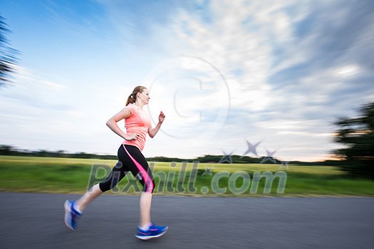 Young woman running outdoors on a lovely sunny winter/fall day (motion blurred image) Young woman running outdoors on a lovely sunny winter/fall day (motion blurred image)