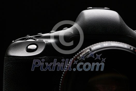 Professional modern DSLR camera low key stock photo/image - Modern DSLR camera with a very wide aperture lens on with highlighted edges against black background Professional modern DSLR camera low key stock photo/image - Modern DSLR camera with a very wide aperture lens on with highlighted edges against black background