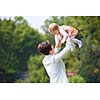 happy mother and baby child in park making first steps .  Walking and hugging.