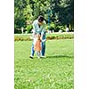 happy mother and baby child in park making first steps .  Walking and hugging.