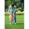 happy mother and baby child in park making first steps .  Walking and hugging.