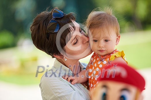 happy mother and baby child in park making first steps . Walking and hugging. happy mother and baby child in park making first steps . Walking and hugging.