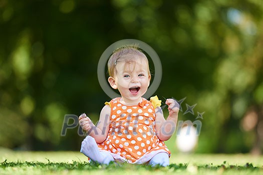 happy young baby child sittng on grass on beautiful summer day in park happy young baby child sittng on grass on beautiful summer day in park