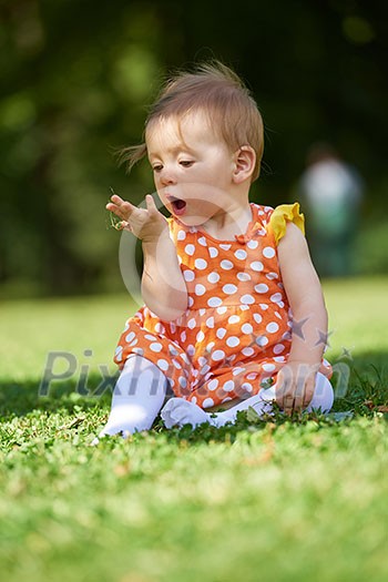 happy young baby child sittng on grass on beautiful summer day in park happy young baby child sittng on grass on beautiful summer day in park