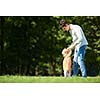 happy mother and baby child in park making first steps .  Walking and hugging.