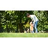 happy mother and baby child in park making first steps .  Walking and hugging.