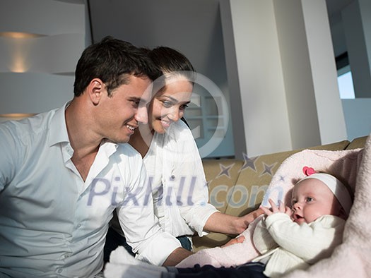 happy young family couple with beautiful new born baby have fun at modern home happy young family couple with beautiful new born baby have fun at modern home