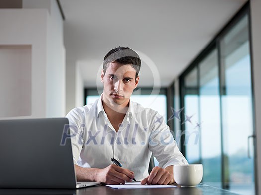 portrait of young happy business man working on laptop computer at home portrait of young happy business man working on laptop computer at home
