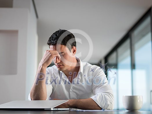 frustrated with problems young business man working on laptop computer at home frustrated with problems young business man working on laptop computer at home