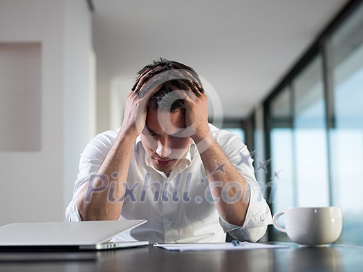frustrated with problems young business man working on laptop computer at home frustrated with problems young business man working on laptop computer at home