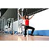 young woman practicing fitness and working out in a gym